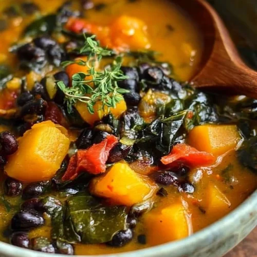 Black bean stew with butternut squash and collard greens served in a bowl