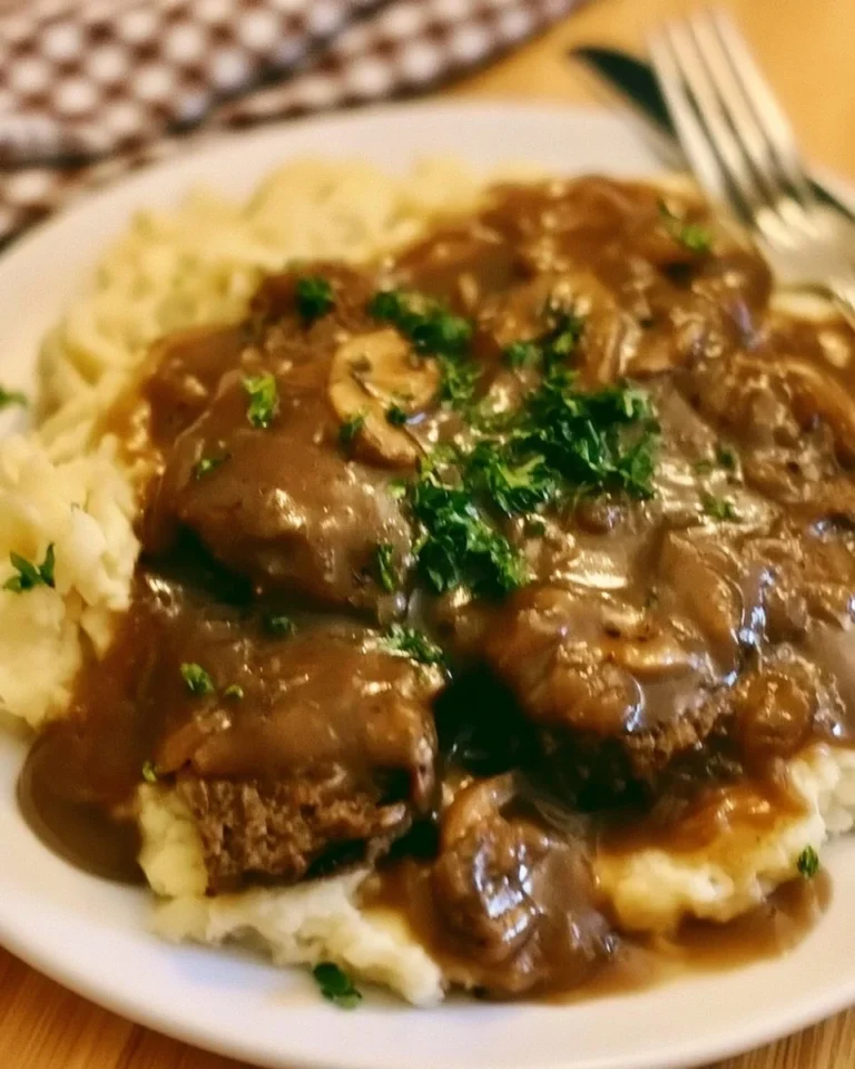 Crock Pot cube steak simmering in rich gravy for a delicious home-cooked meal