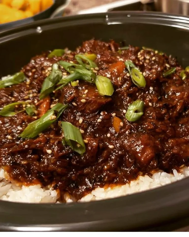 Crockpot Korean BBQ served with rice and garnish on a plate.