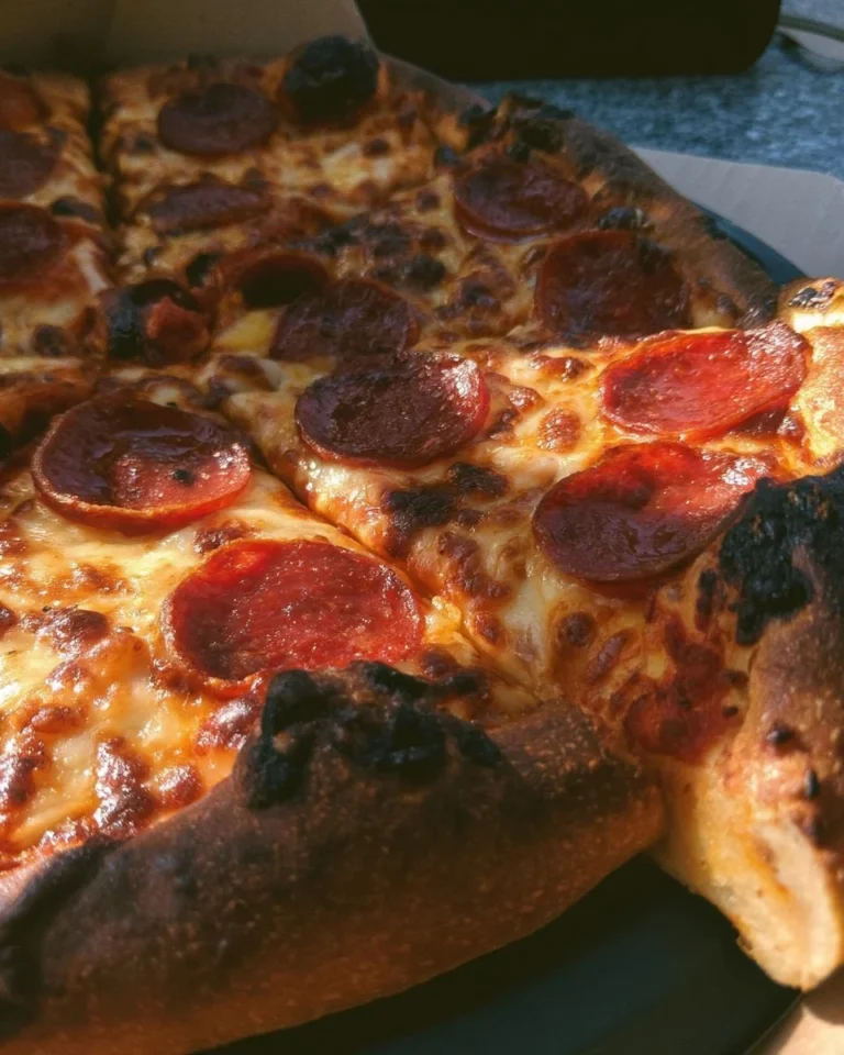 Freshly baked delicious pizza with toppings on a wooden table
