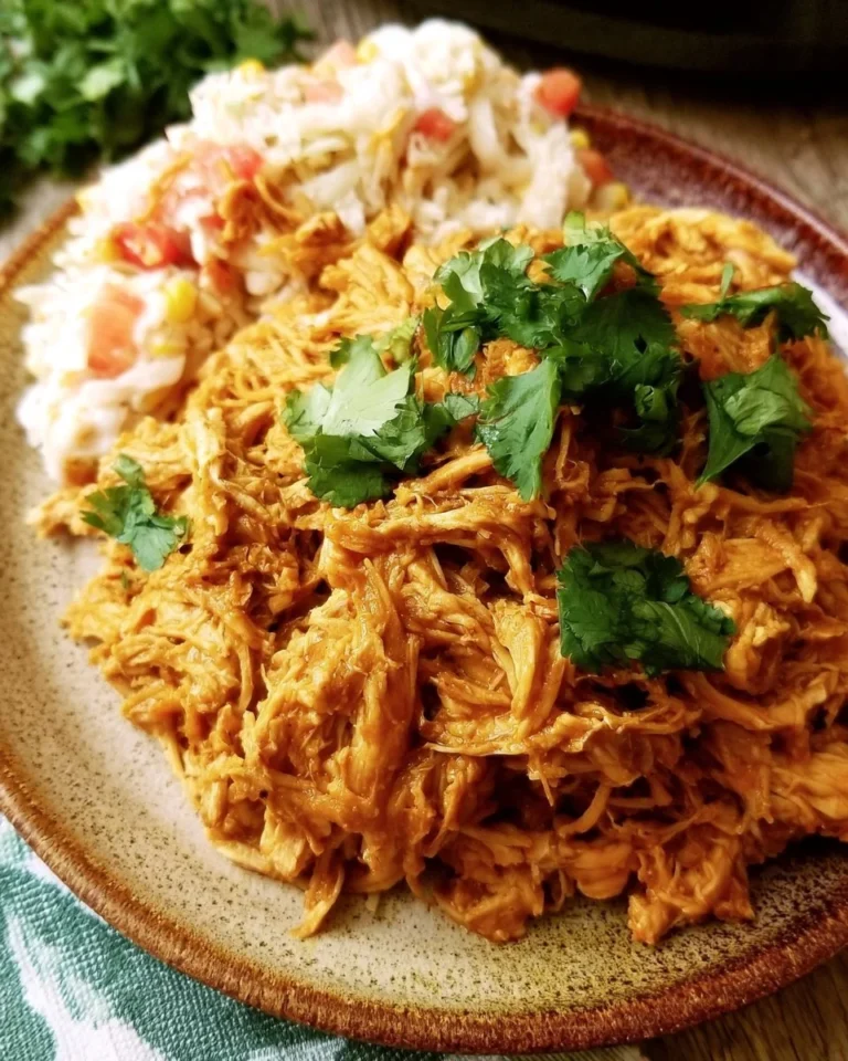 Easy 3-ingredient crock pot chicken tacos on a plate with fresh toppings