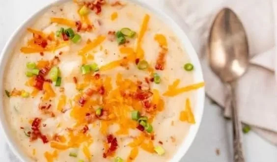Bowl of easy crock pot potato soup garnished with green onions.
