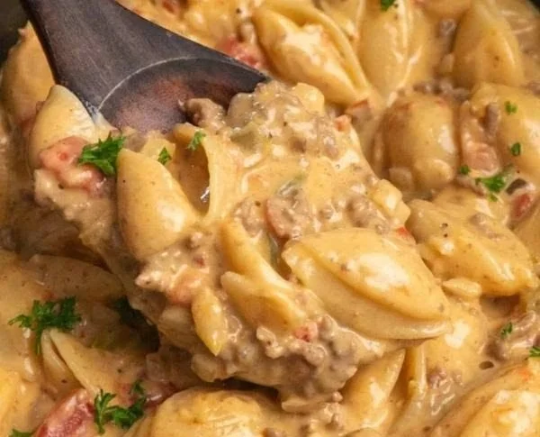 Creamy Rotel Pasta dish garnished with fresh herbs and cheese