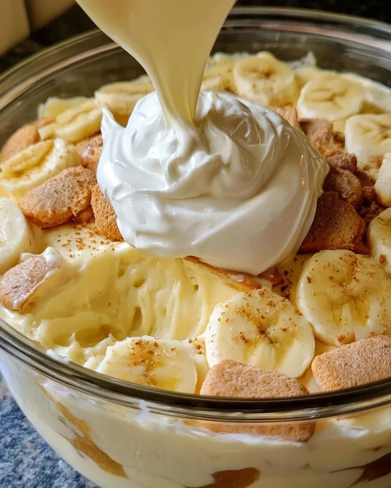 Delicious homemade banana pudding topped with whipped cream and banana slices